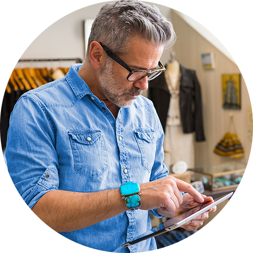 Man in retail store looking at tablet